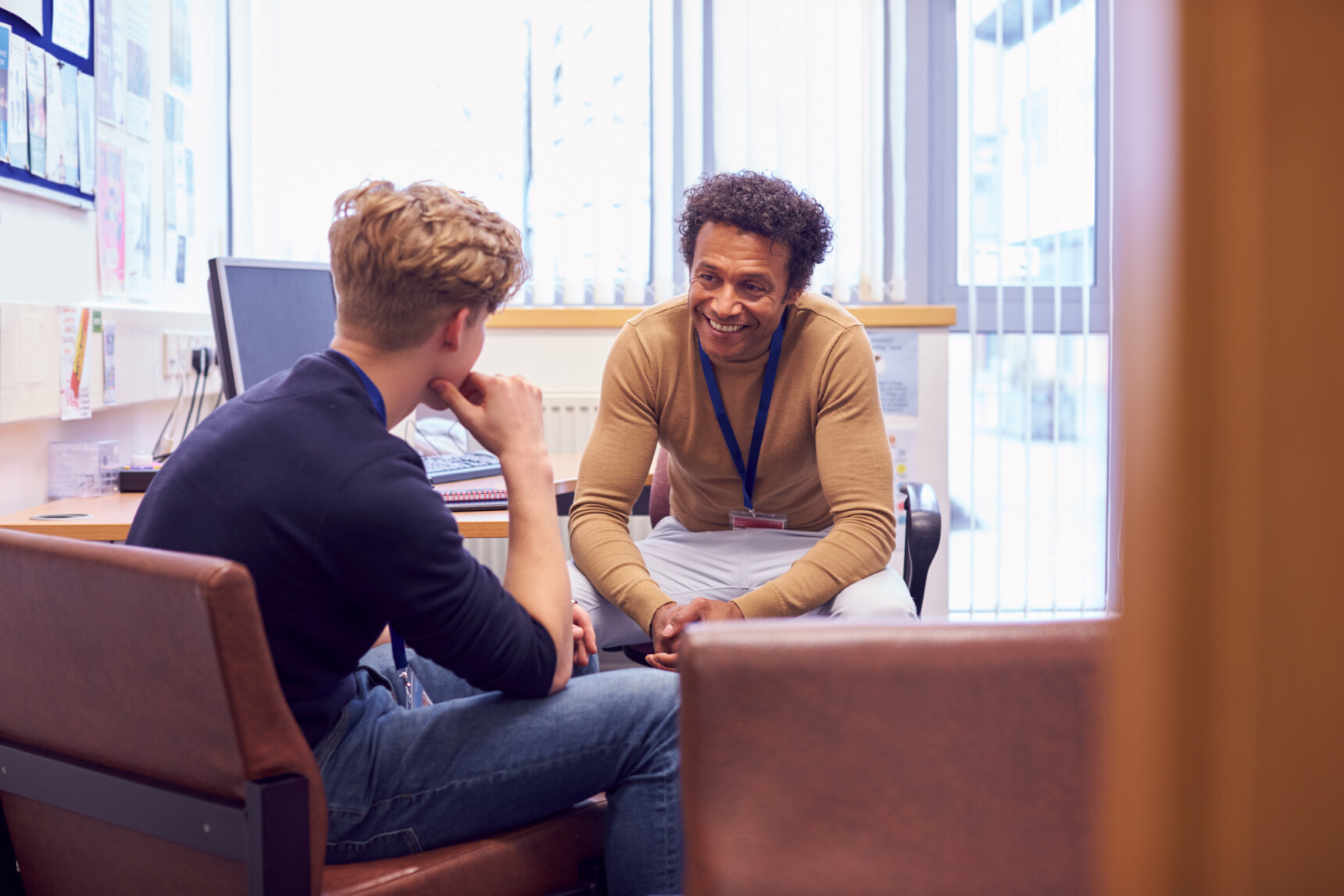 Teenage boy discussing post-16 options with a teacher.