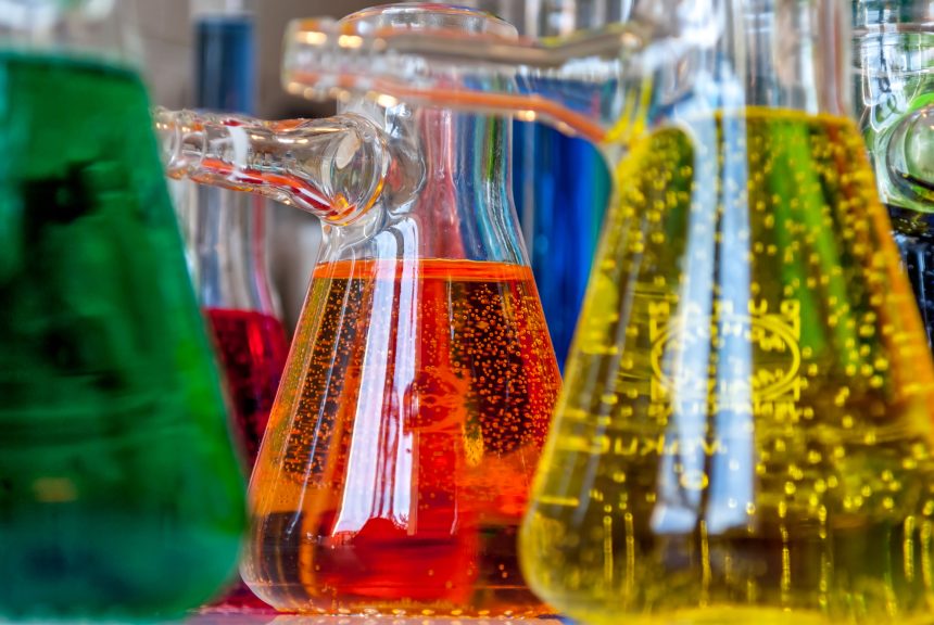 A group of conical flasks filled with colourful solutions.