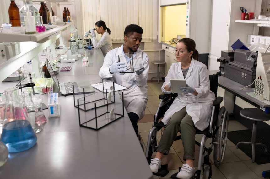 A female scientist using a wheelchair in the laboratory. Many places of learning and work are not accessible for wheelchair users.
