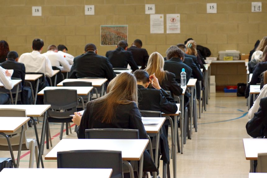Students sitting exams in an exam hall.