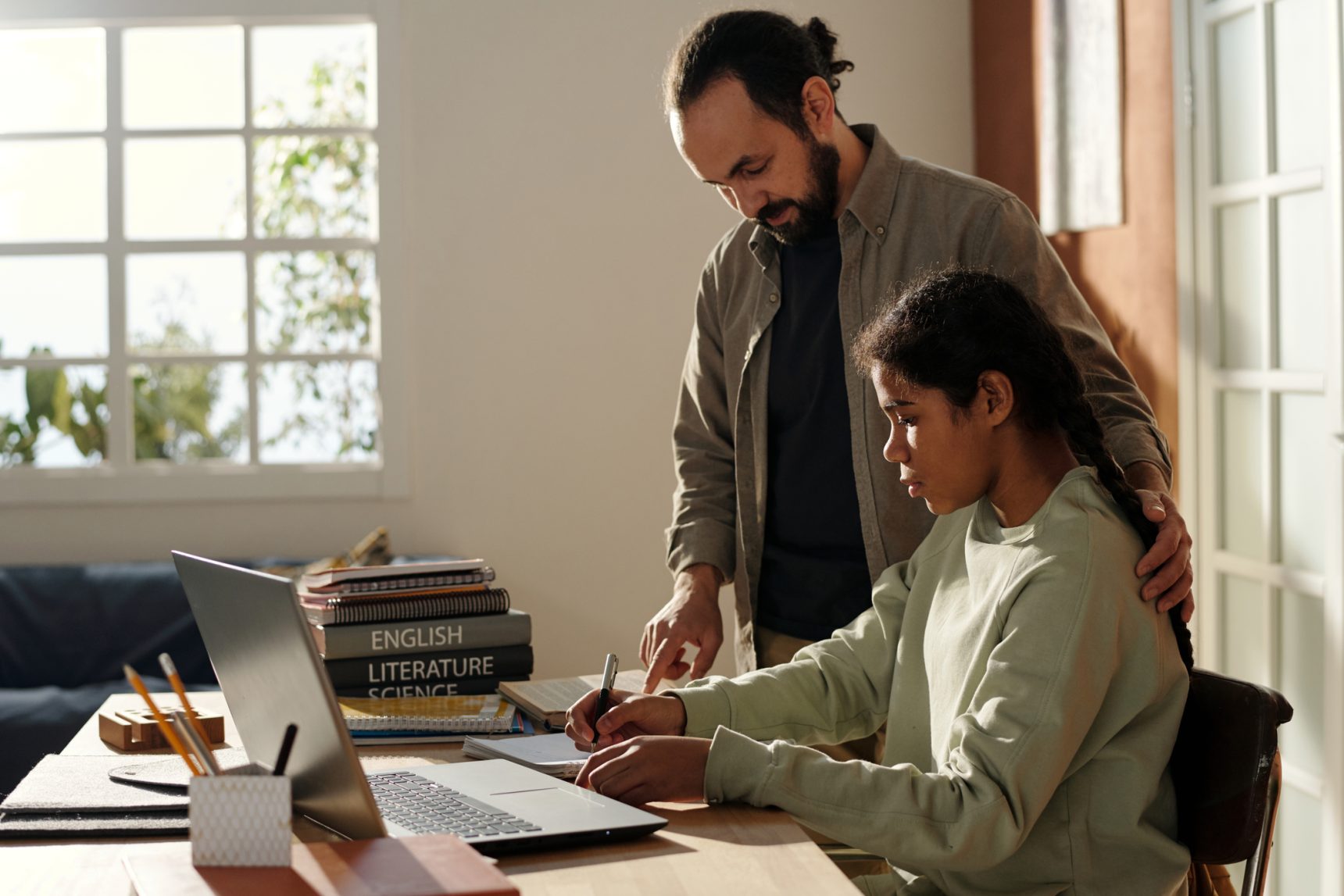 Father helping daughter with revision the night before her exam.
