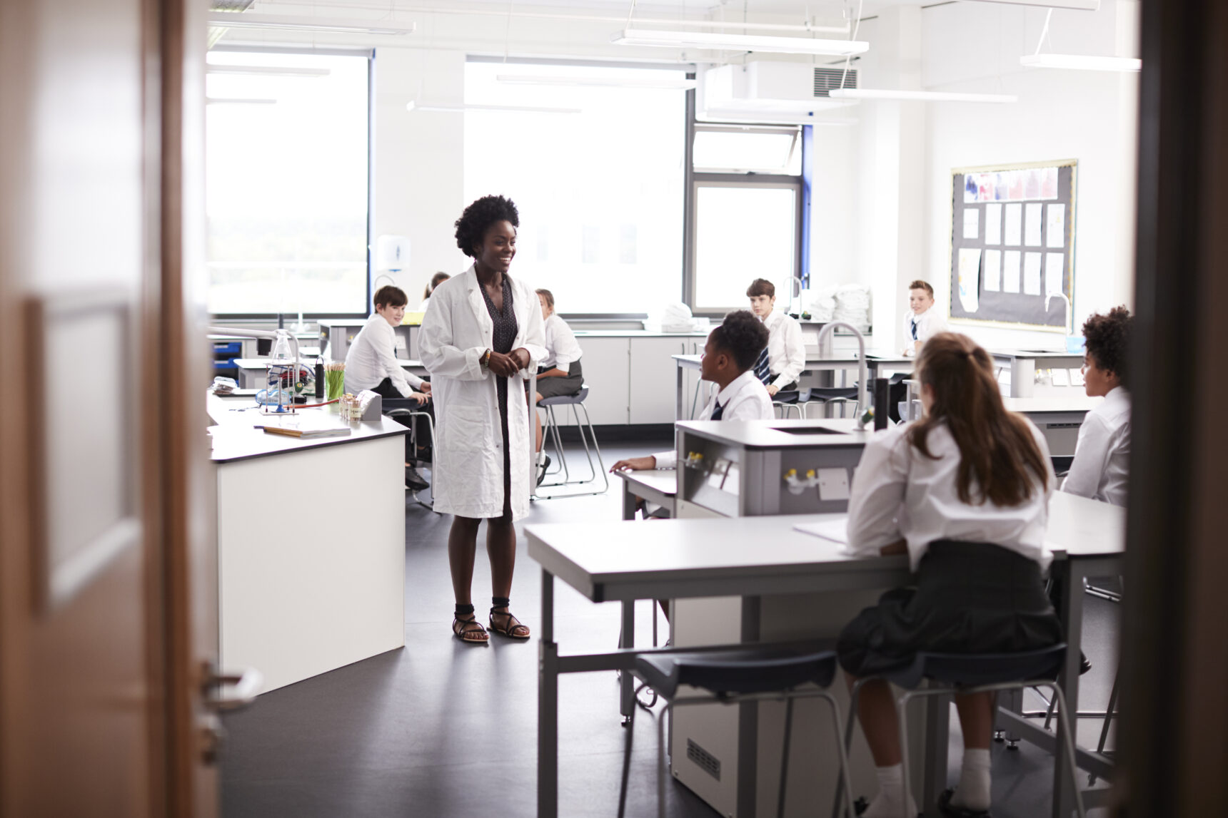 A teacher is speaking to combined science GCSE students in a science classroom.