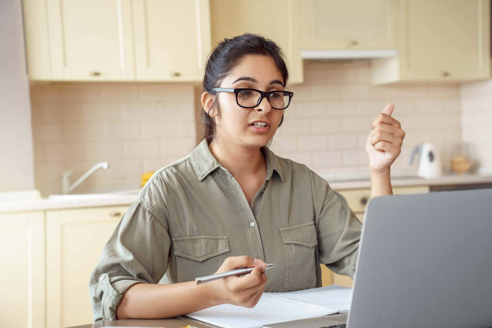 Female teacher at desk doing online CPD course.
