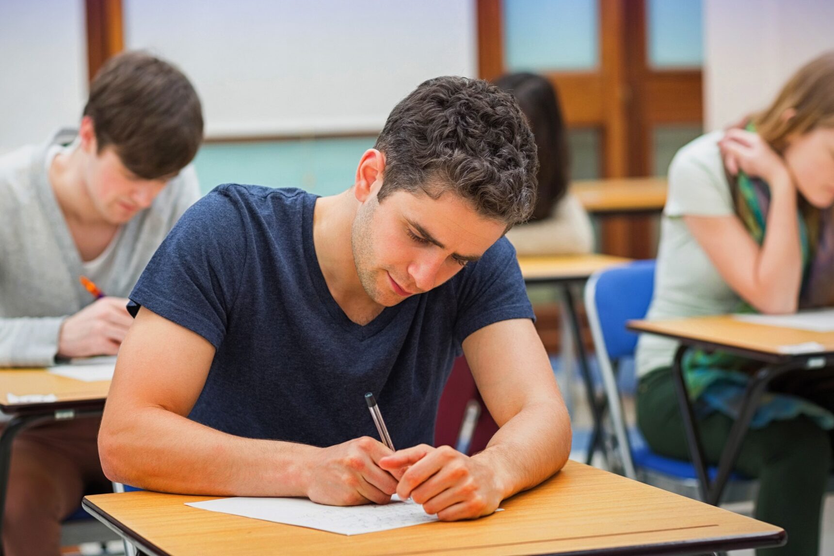 A Level students are taking an exam in an exam hall.