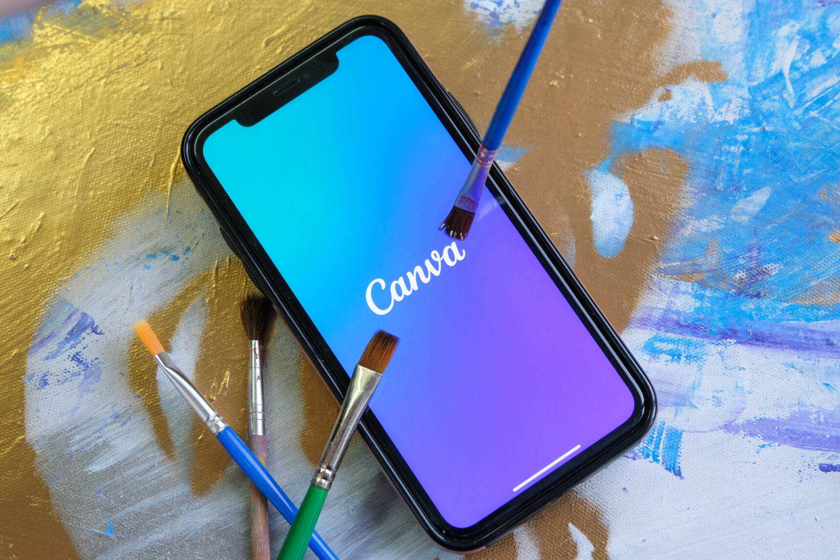 Mobile phone showing a picture of the Canva graphic design app, one of the best creative classroom apps.