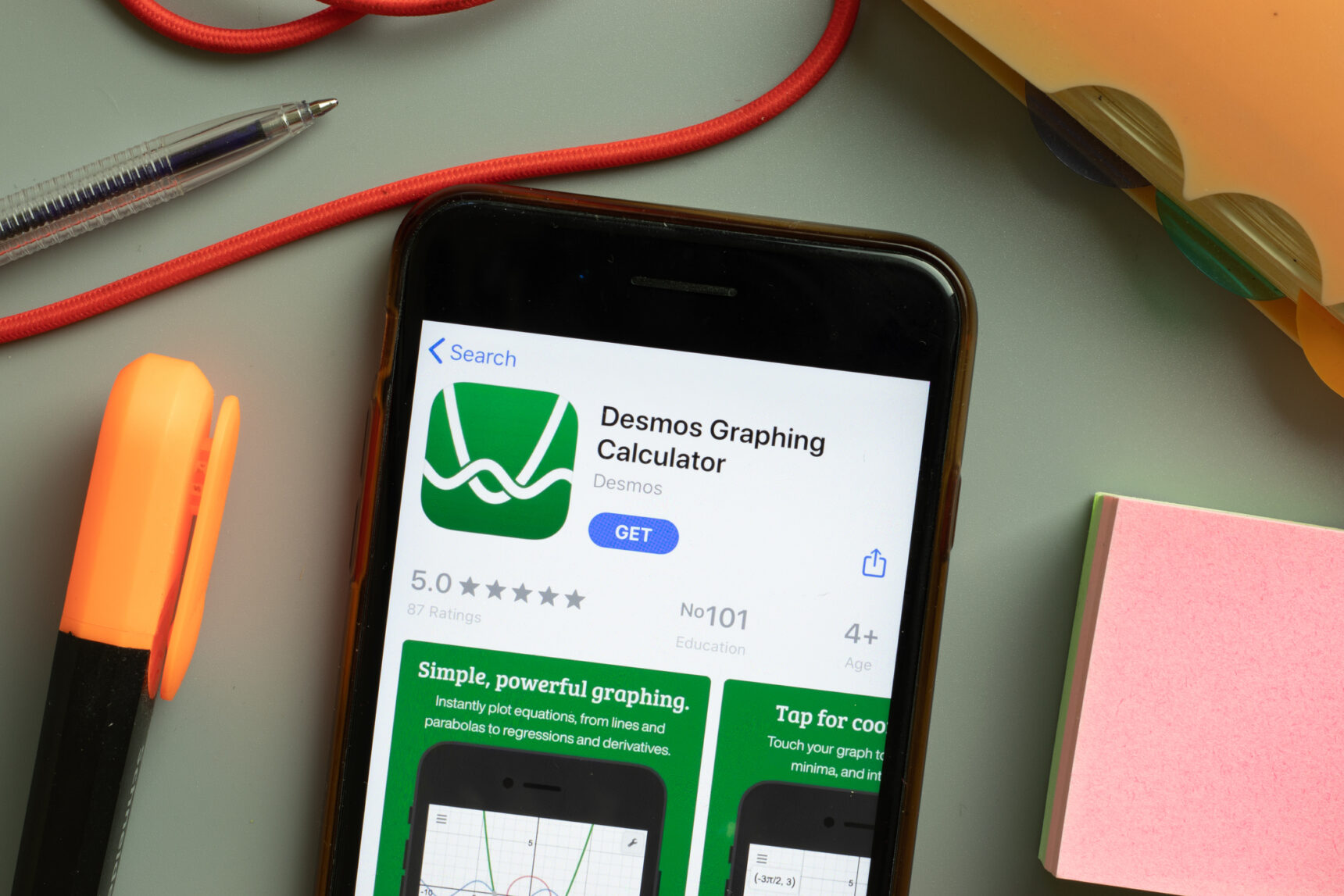 A mobile phone lying on a desk showing the Desmos app, one of the best teacher apps for maths.