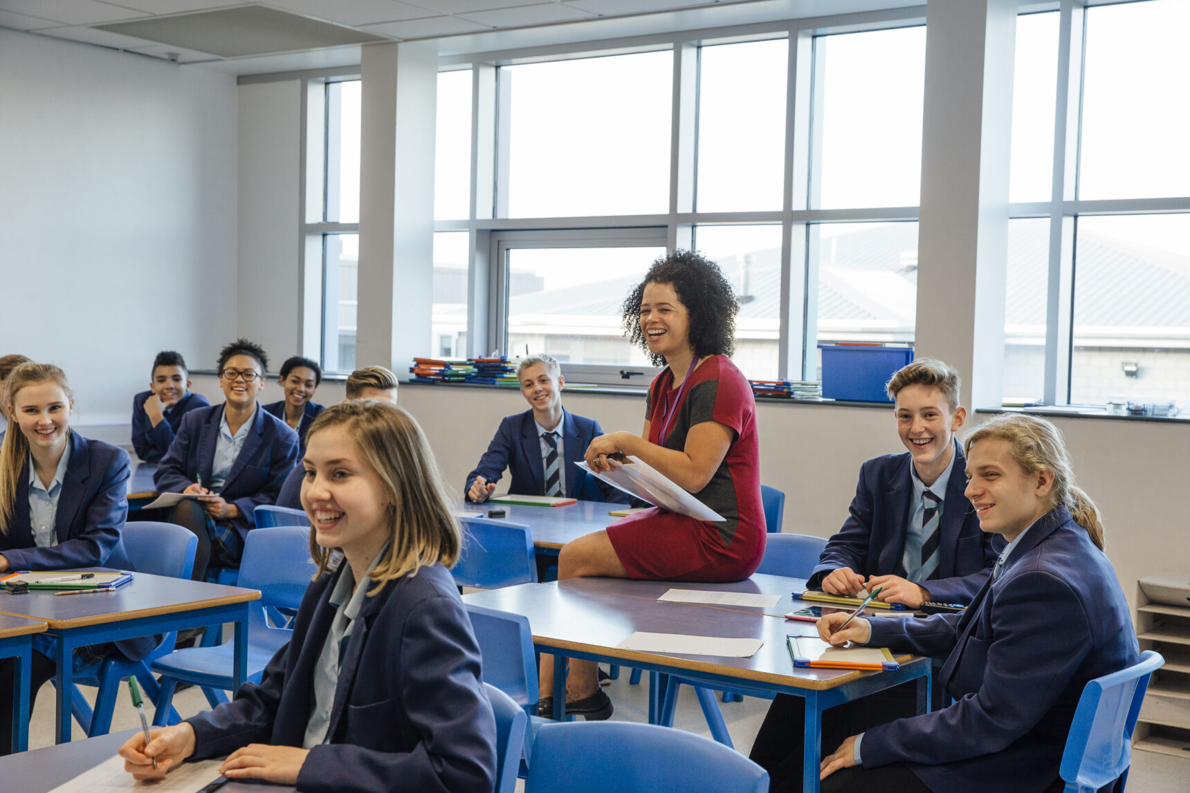 Students participating in a teacher-led activity with mini whiteboards.