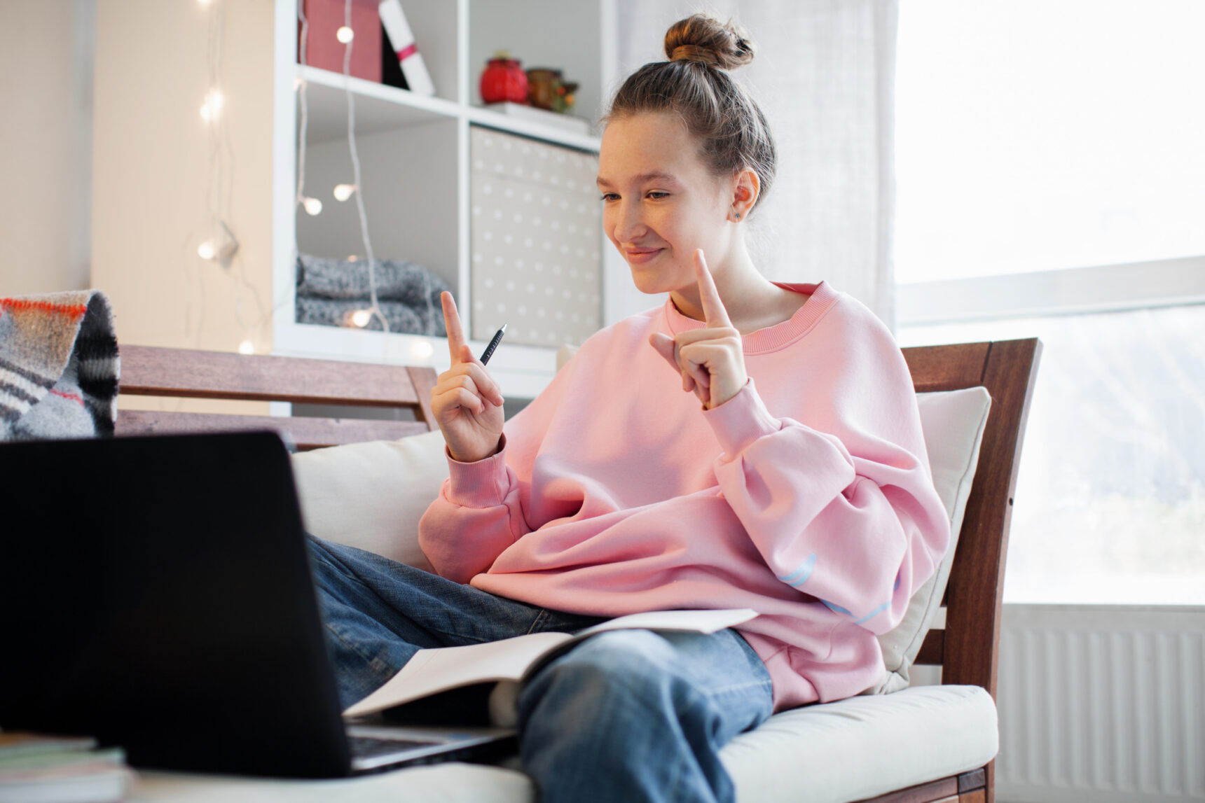 A student speaks to tutor during an online tuition session before exams.