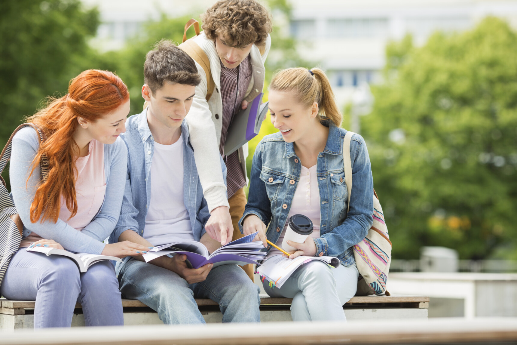 A group of studetns are chatting outside at a university open day.
