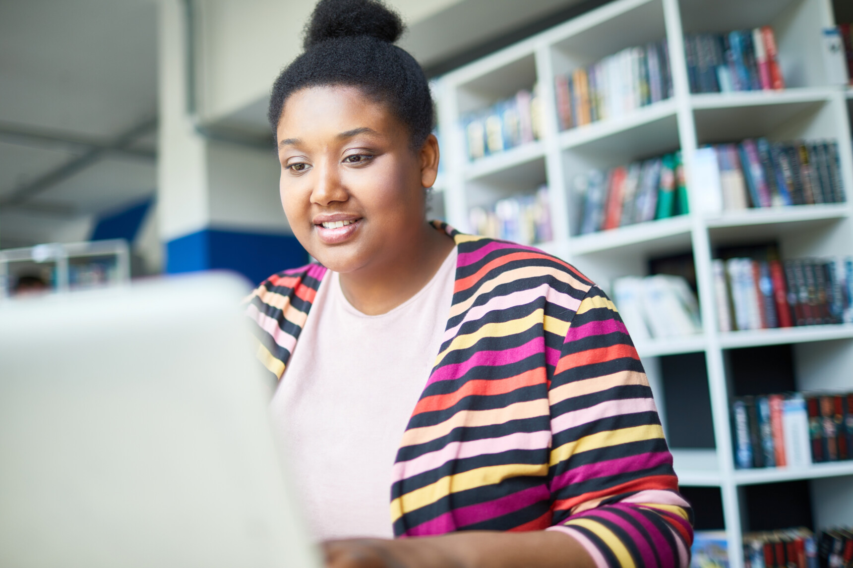 Young prospective student on laptop attending a university virtual open day.