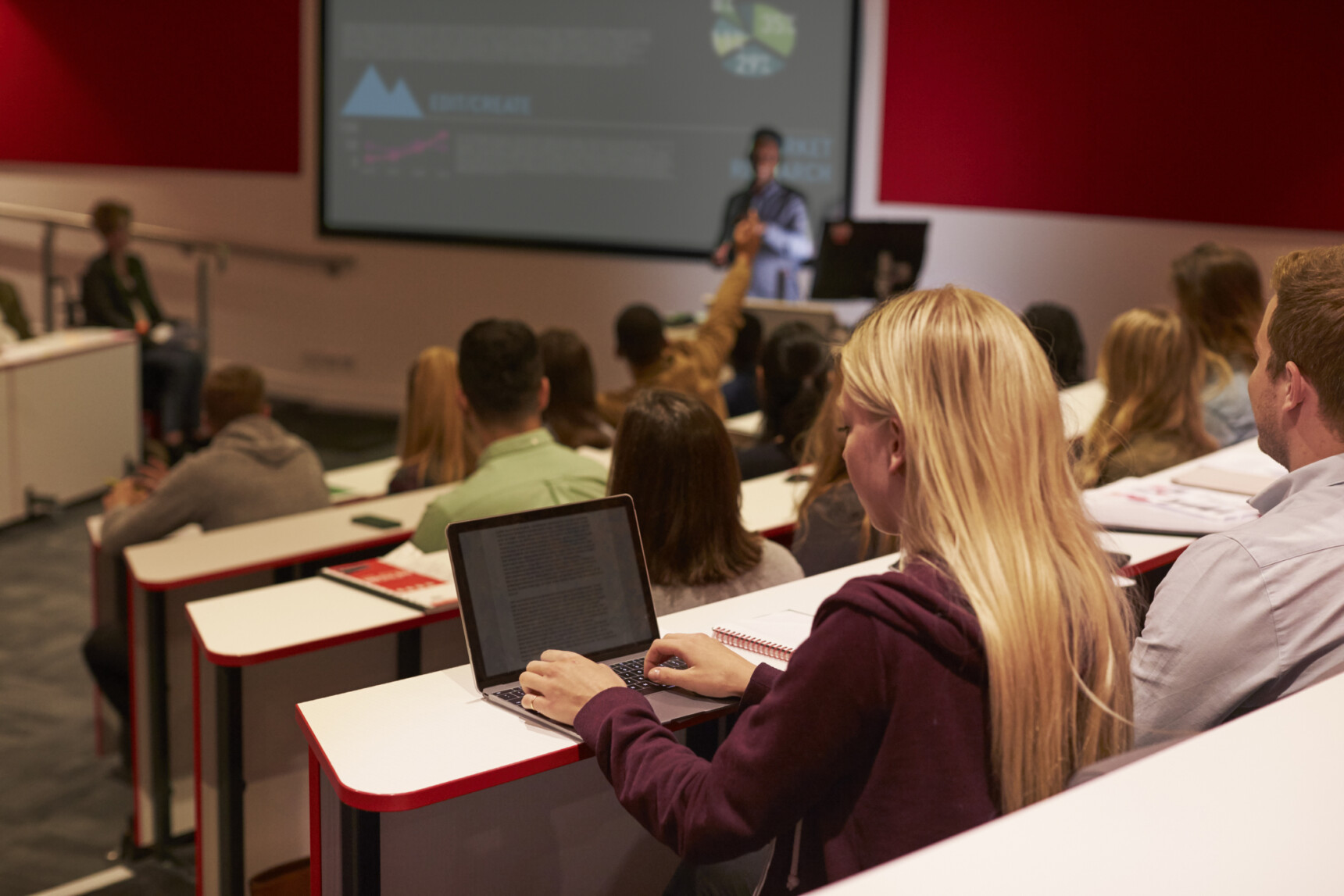 A lecture theatre full of prospective university students attending a subject talk at a university open day.