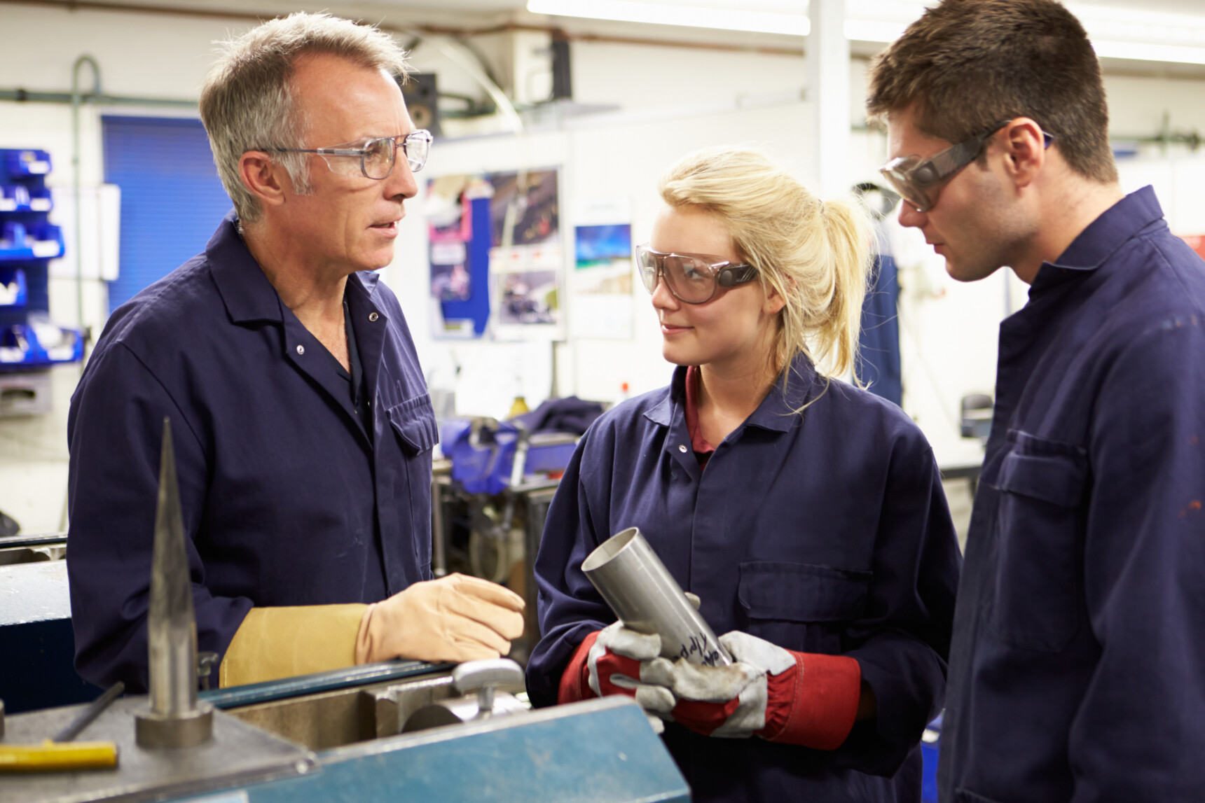 Students on a BTEC engineering course receving instruction from a tutor.